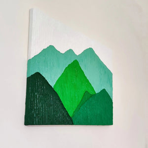 Side view of textured green mountain landscape painting showcasing its depth and details.