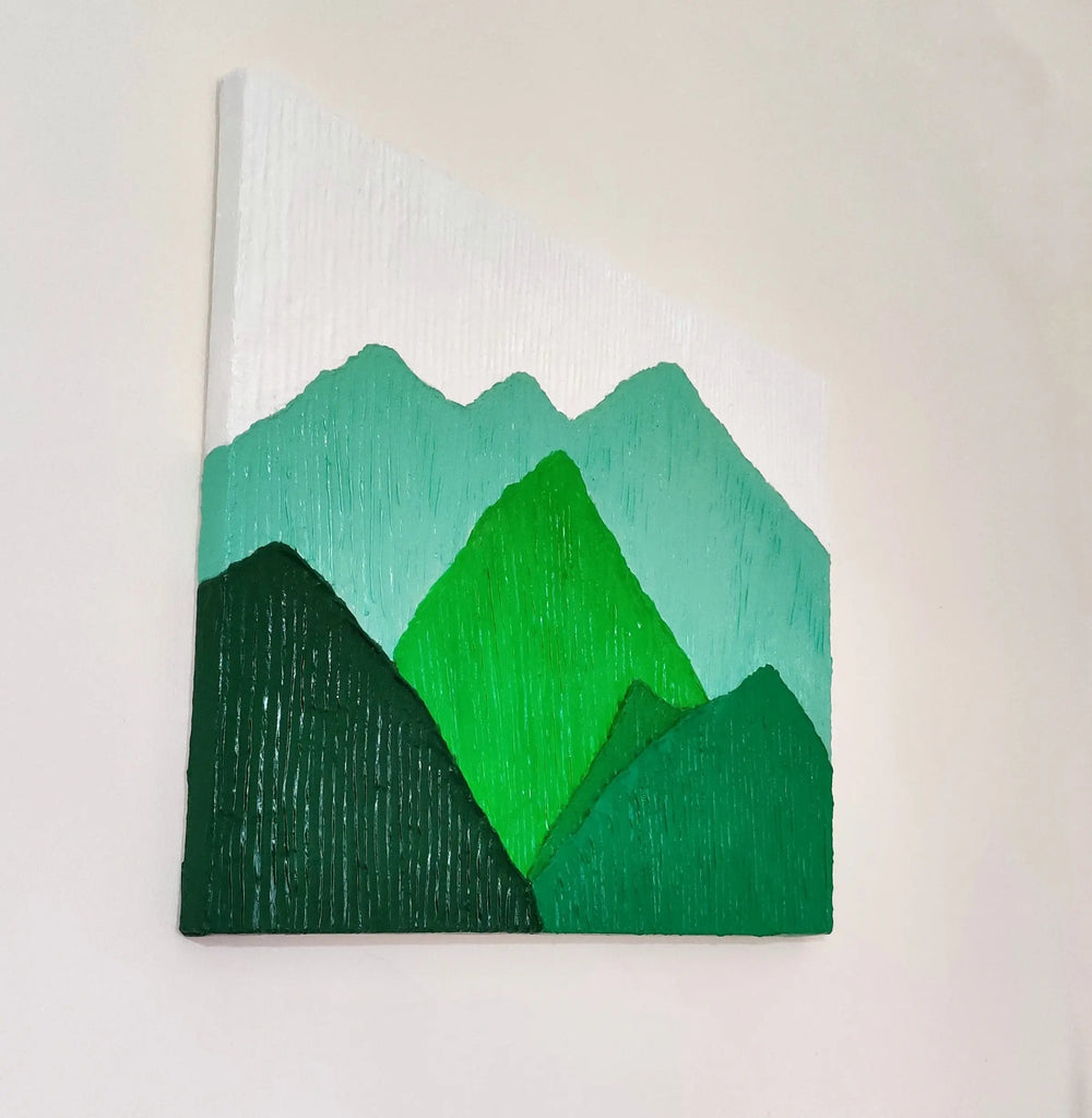 Side view of textured green mountain landscape painting showcasing its depth and details.