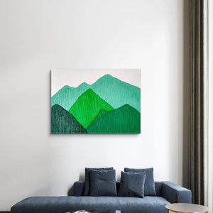 Modern green mountain landscape painting above a dark blue sofa in a contemporary living room.