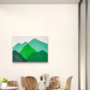 Textured mountain landscape artwork in green hues displayed in a modern dining area.