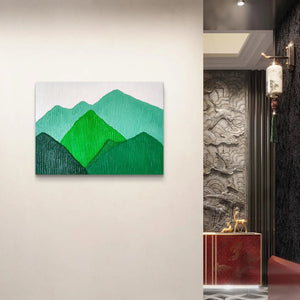 Elegant green mountain landscape painting in a luxurious hallway setting.