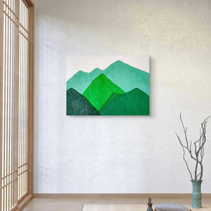 Textured mountain landscape artwork in green tones displayed in a serene Japanese-style room.