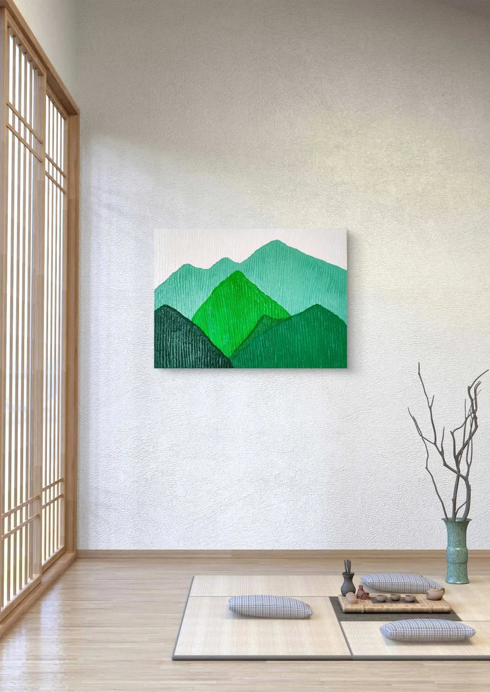Textured mountain landscape artwork in green tones displayed in a serene Japanese-style room.