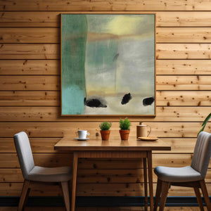 a table with two chairs and a painting on the wall