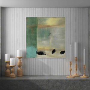 a painting hanging on a wall next to candles