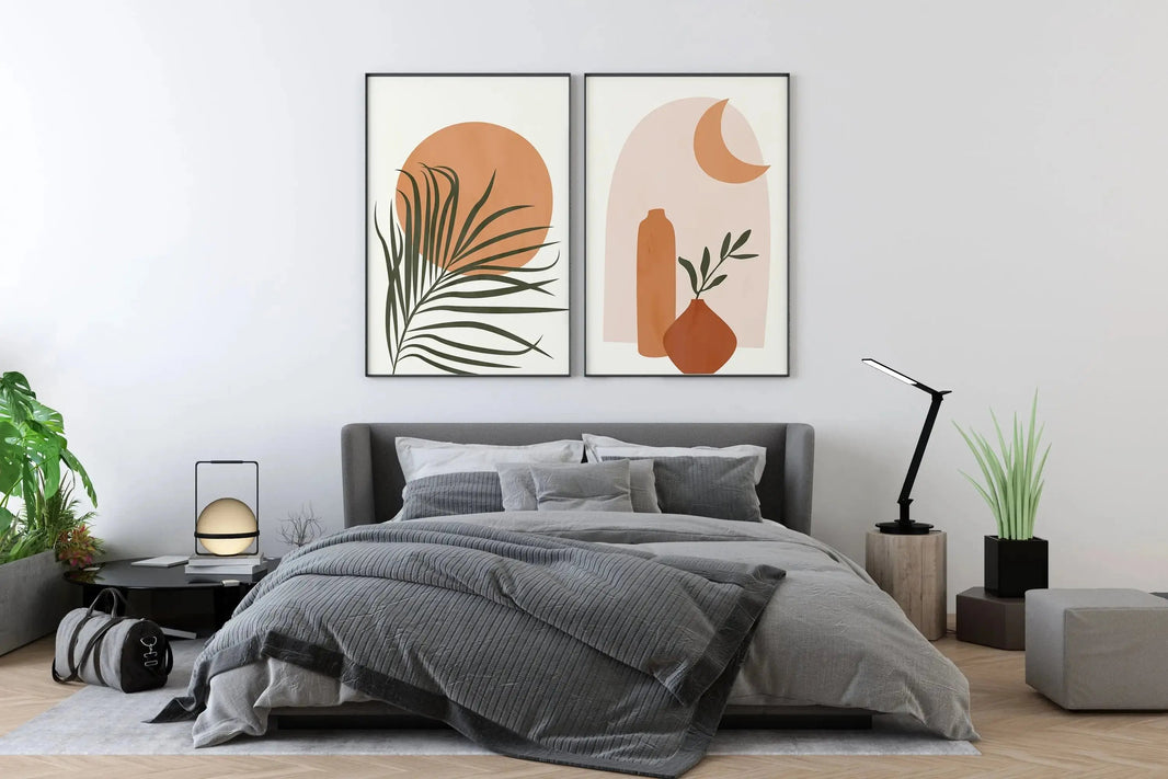 a bedroom with a bed and two paintings on the wall