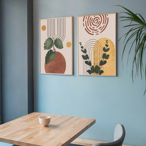 Modern boho digital artwork with leafy designs displayed in a cafe setting.