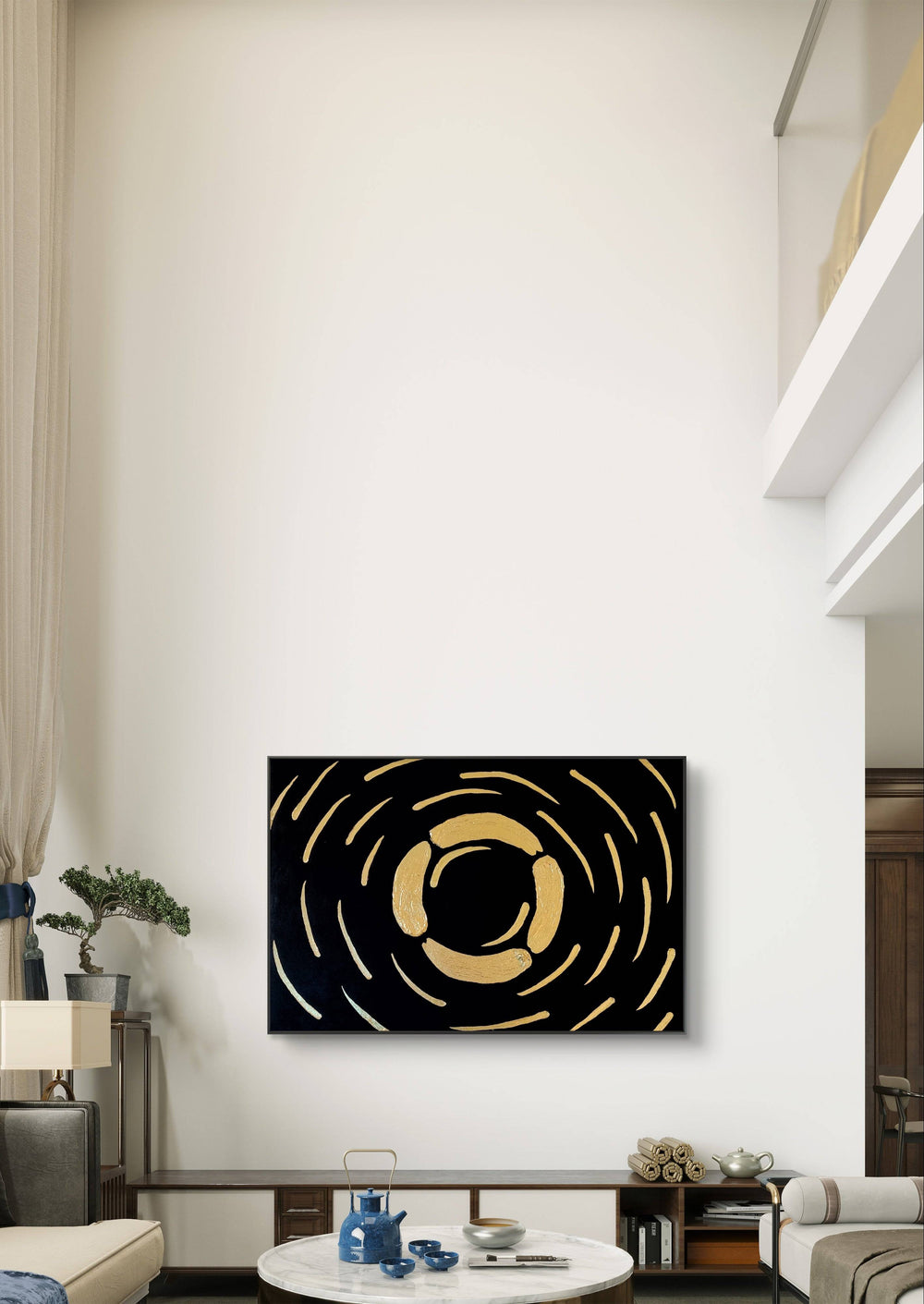 Gold and black abstract textured painting hung in a high-ceilinged living space with minimalist decor.