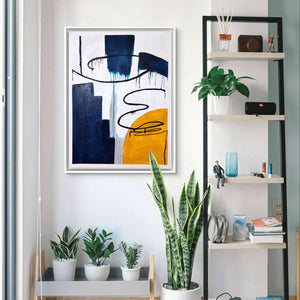 Modern abstract handmade painting with bold blue, yellow, and black textures in a bright living room.