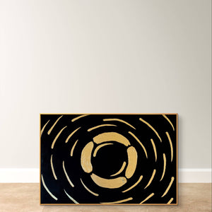 Abstract textured painting with gold and black design, leaning against a neutral wall on a tiled floor.