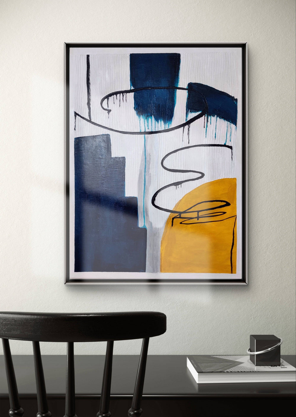 Modern abstract painting featuring blue and yellow tones in a minimalist office setting.