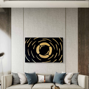Abstract textured painting with gold accents on black background, showcased in a modern living room with neutral tones.