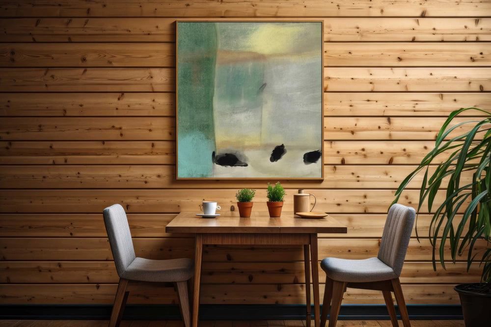 a table with two chairs and a painting on the wall