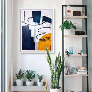 Modern abstract handmade painting with bold blue, yellow, and black textures in a bright living room.