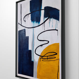 Close-up of a modern abstract painting with textured blue, yellow, and black details in a black frame.