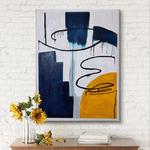 Handmade abstract painting with bold colors displayed on a white brick wall above a wooden console.